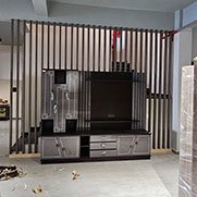 Vertical slat partition with a built in TV unit